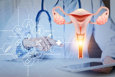 Doctor with modern tablet at table and virtual image of uterus and icons