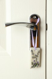 Scented sachet with flowers hanging on door handle