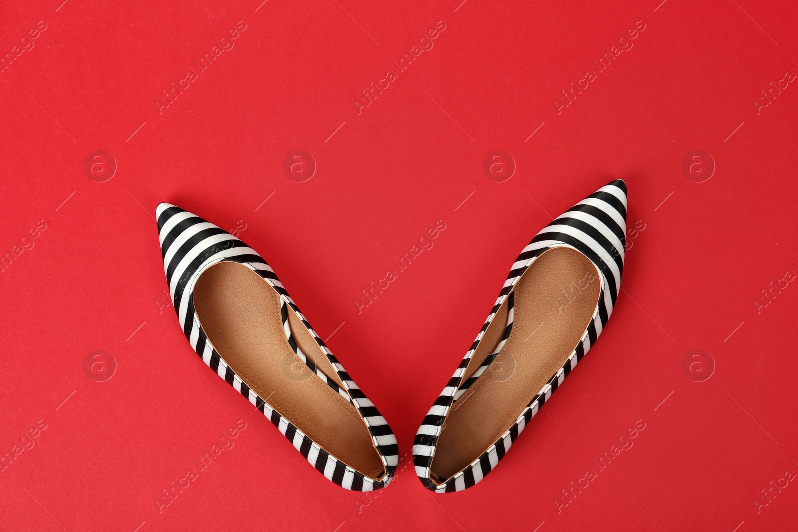 Photo of Pair of female shoes on color background, top view