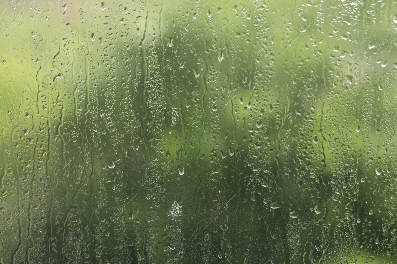 Photo of Window glass with raindrops as background, closeup