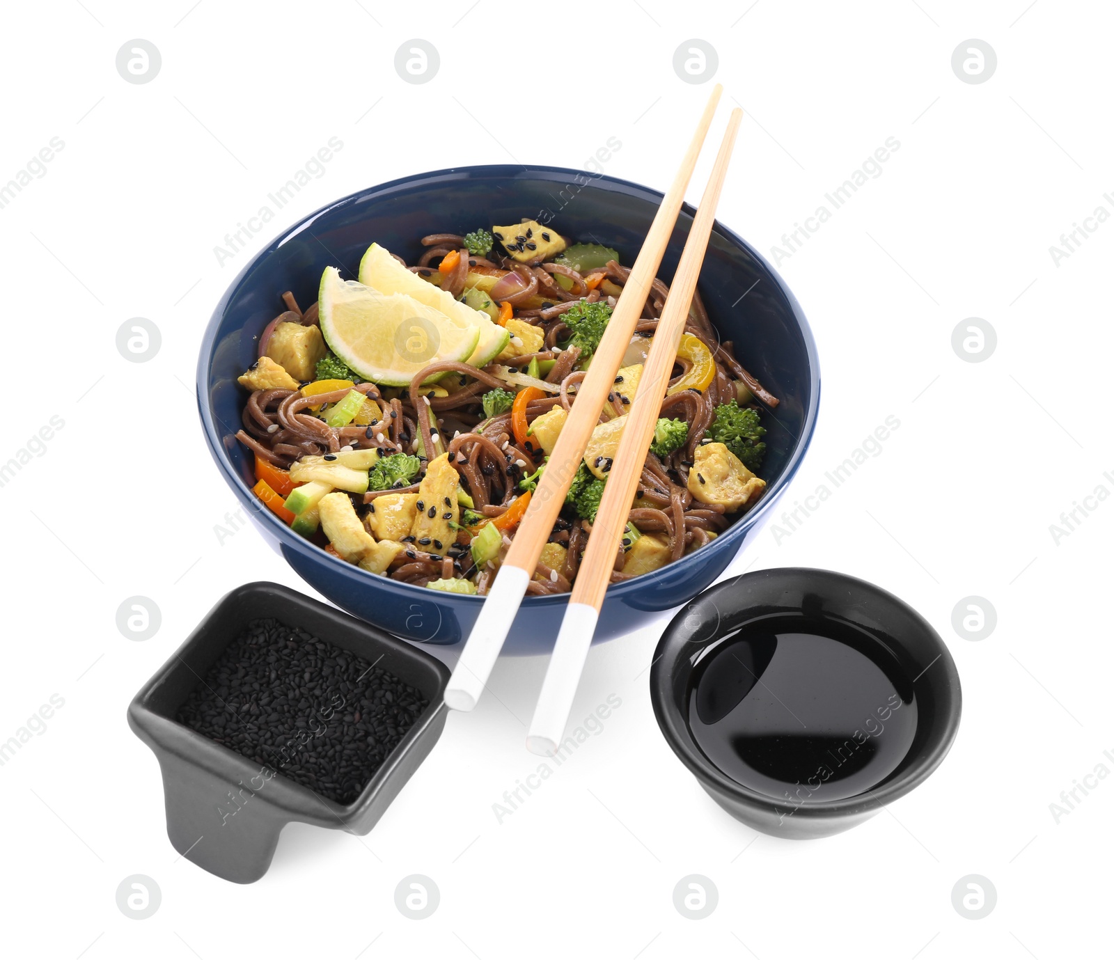 Photo of Stir-fry. Delicious cooked noodles with chicken in bowl, soy sauce and sesame on white background