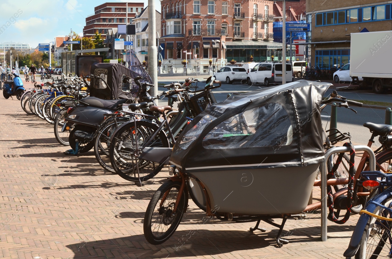 Photo of Many parked bikes and bicycles for rent on city street