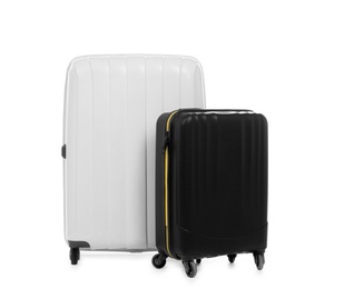 Photo of New suitcases packed for journey on white background