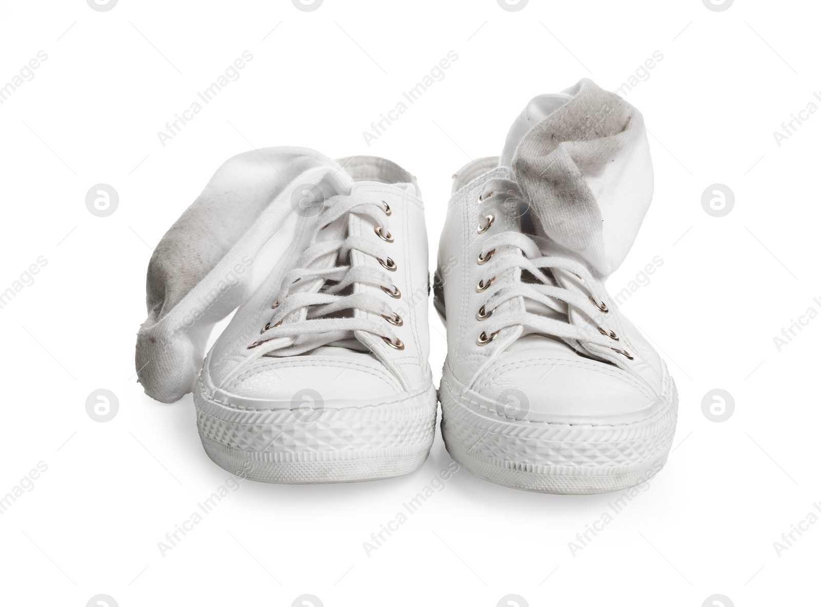 Photo of Dirty socks and sneakers on white background