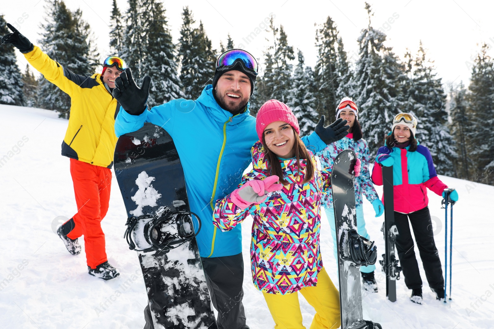 Photo of Group of friends with equipment in snowy mountains. Winter vacation