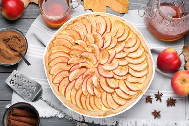 Flat lay composition with tasty apple pie on grey wooden table