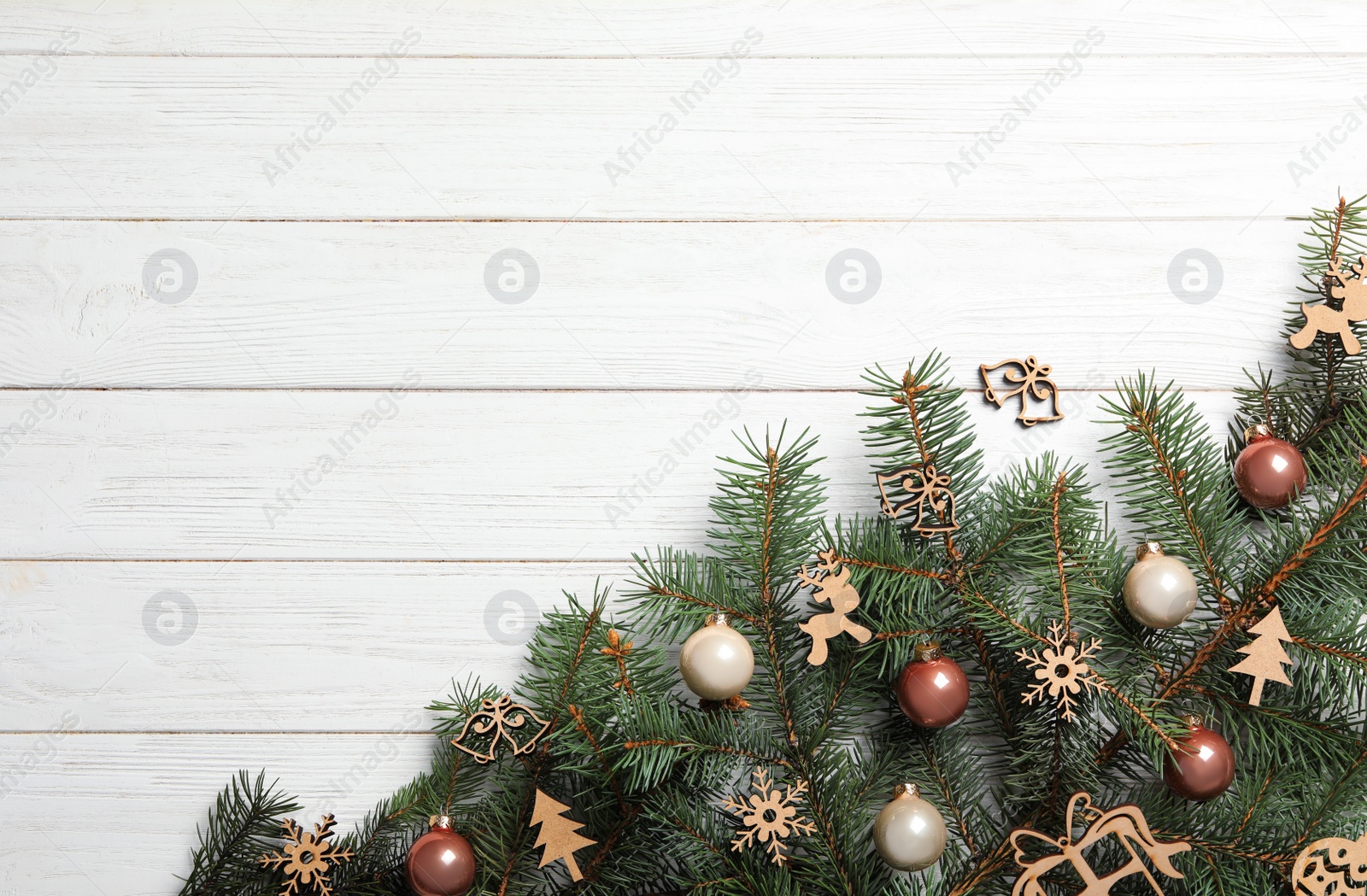 Photo of Christmas decorations on white wooden background, top view. Space for text