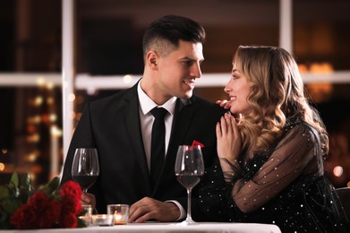 Lovely couple having romantic dinner on Valentine's day in restaurant