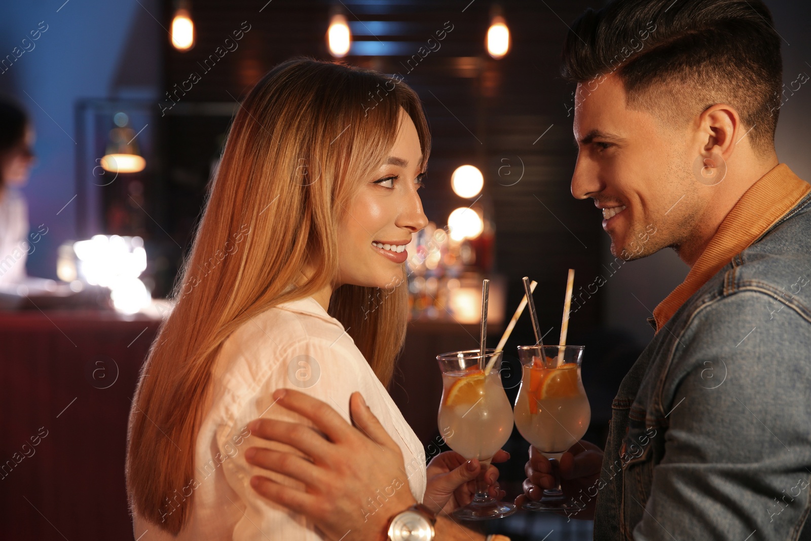 Photo of Man and woman flirting with each other in bar