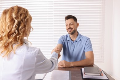 Doctor shaking hands with patient in clinic