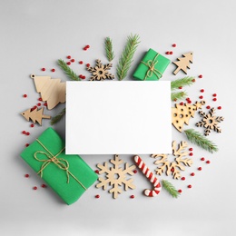 Photo of Composition with Christmas decor and blank card on white background, top view