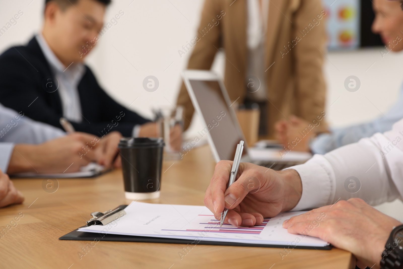 Photo of Businesswoman having meeting with her employees in office, closeup