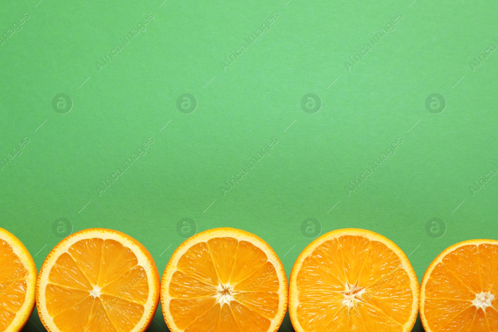 Photo of Flat lay composition with ripe oranges and space for text on color background