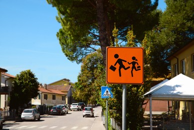 Photo of Children Crossing road sign on city street, space for text