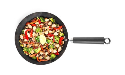 Photo of Stir-fry. Tasty noodles with meat and vegetables in wok isolated on white, top view