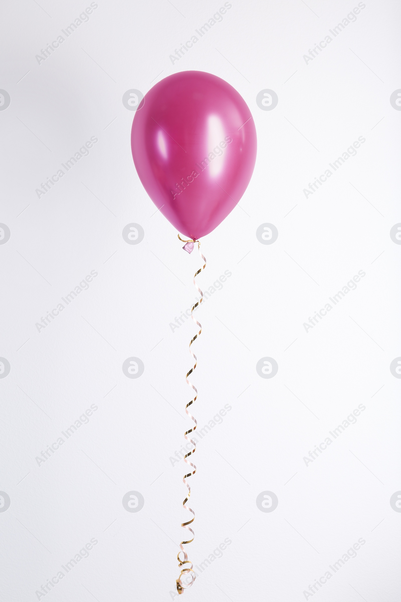 Photo of Color balloon with ribbon on white background
