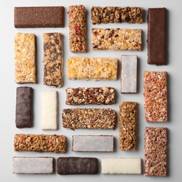 Photo of Flat lay composition with protein bars on grey background