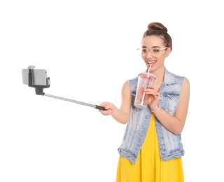 Young beautiful woman taking selfie against white background