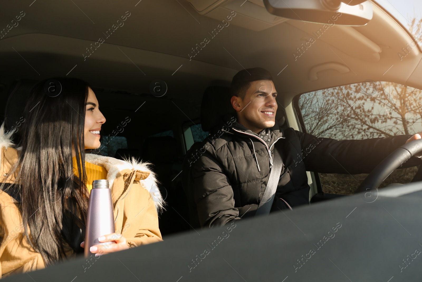 Photo of Happy couple in modern car. Family travel