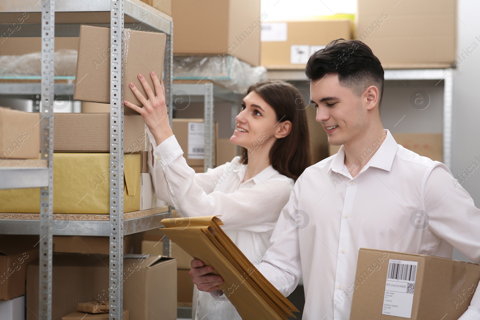 Photo of Young post office employees working in warehouse