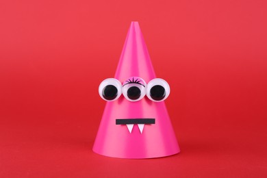 Photo of Spooky paper Halloween monster on red background