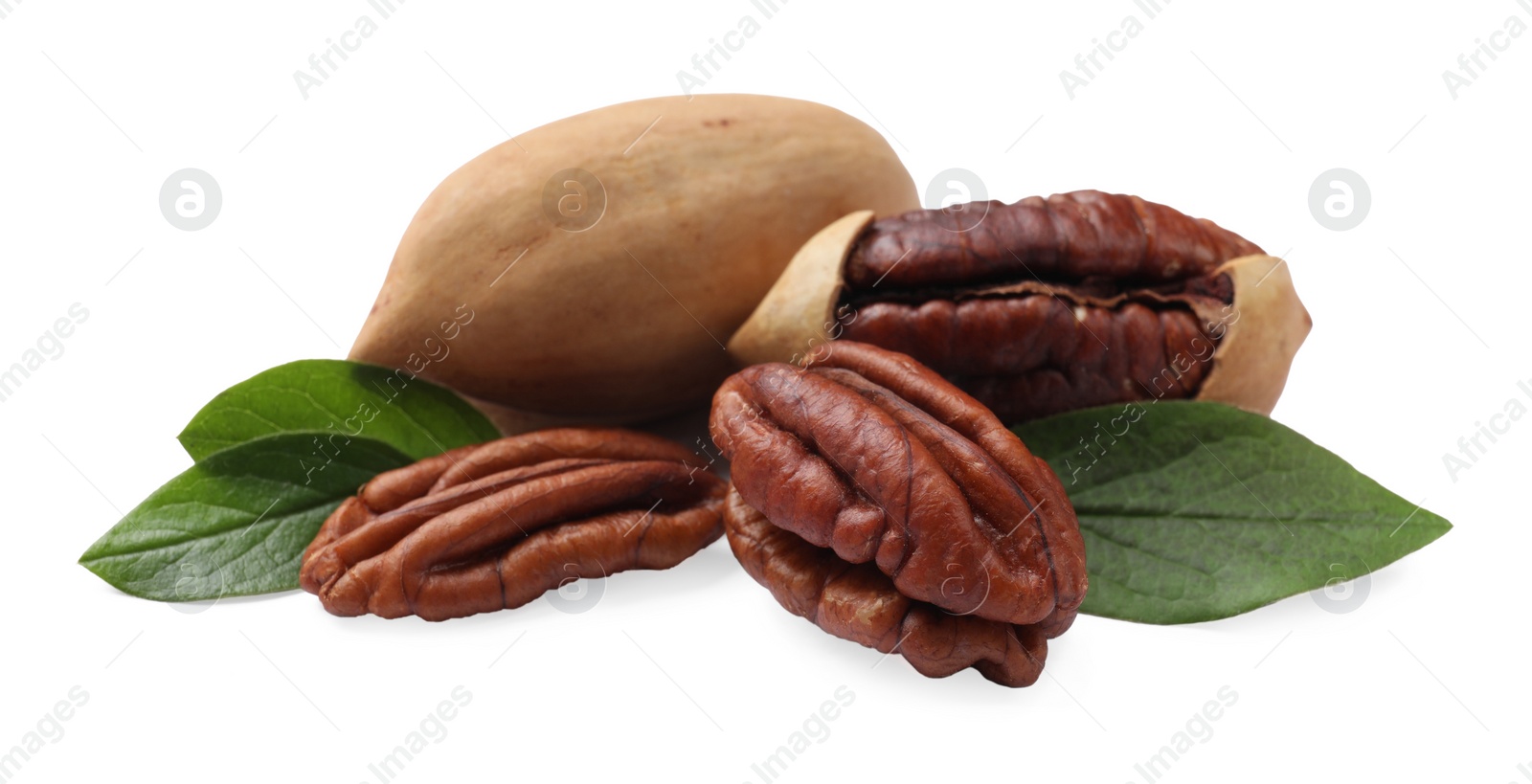 Photo of Many tasty pecan nuts with green leaves isolated on white