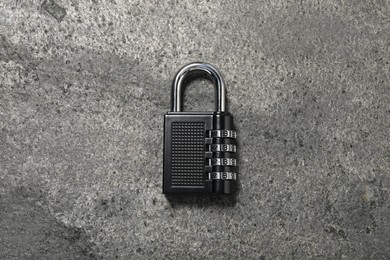 Photo of One steel combination padlock on grey table, top view