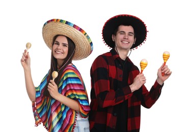 Photo of Lovely couple in Mexican sombrero hats with maracas on white background