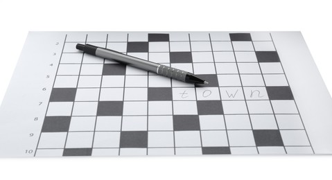 Blank crossword and pen on white background