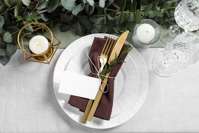 Luxury table setting with beautiful decor and blank card, flat lay. Festive dinner