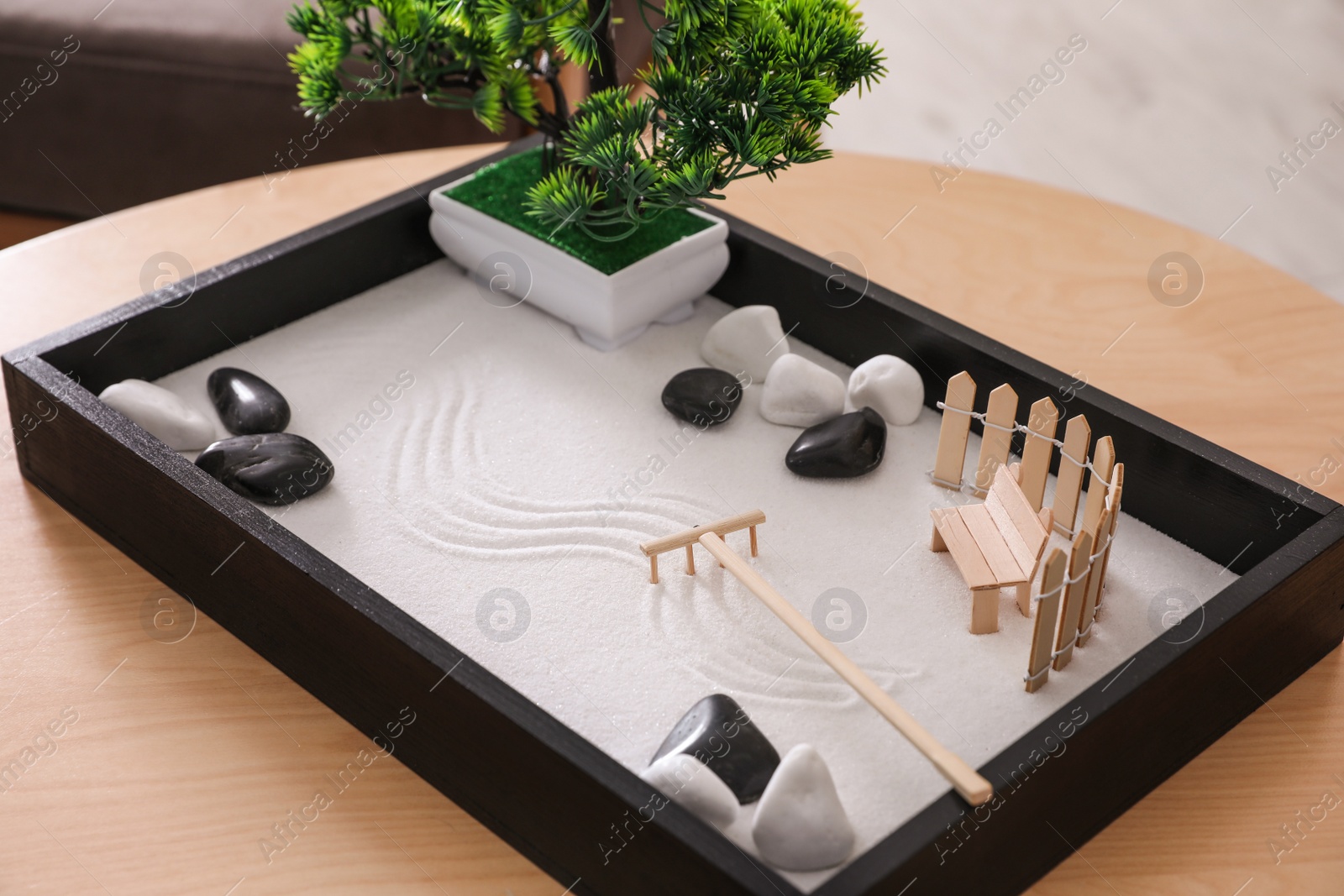 Photo of Beautiful miniature zen garden on wooden table
