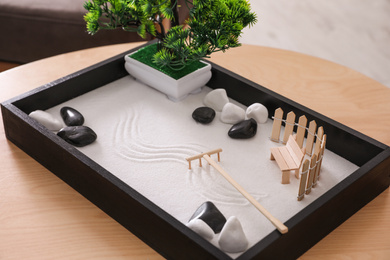 Beautiful miniature zen garden on wooden table