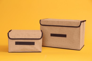 Two textile storage cases on yellow background