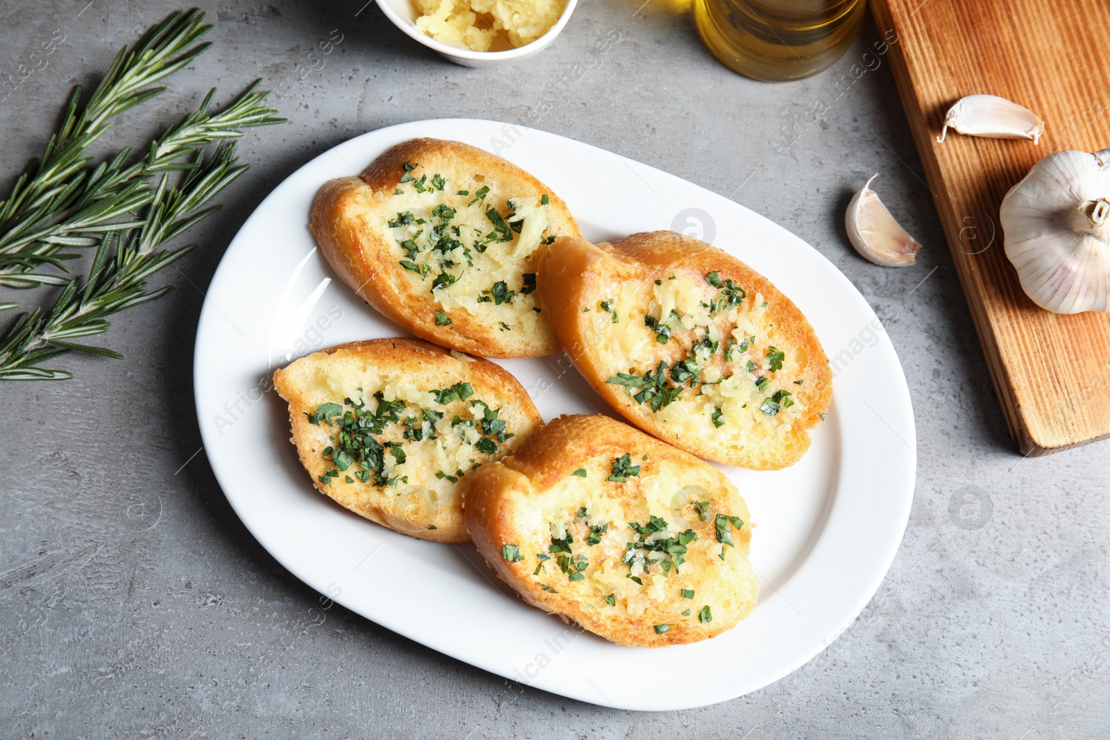 Photo of Flat lay composition with tasty garlic bread on table