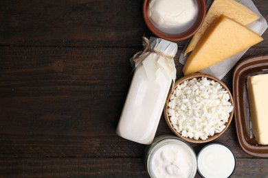 Different fresh dairy products on wooden table, top view. Space for text