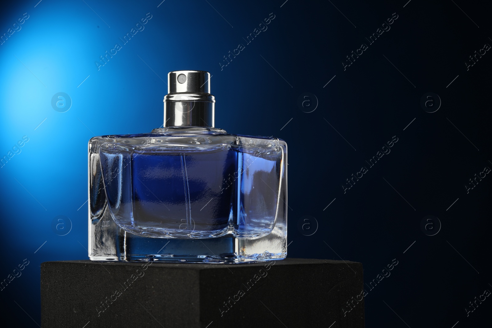 Photo of Luxury men`s perfume in bottle against dark background, space for text