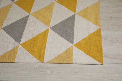 Soft carpet with pattern on white laminated floor indoors