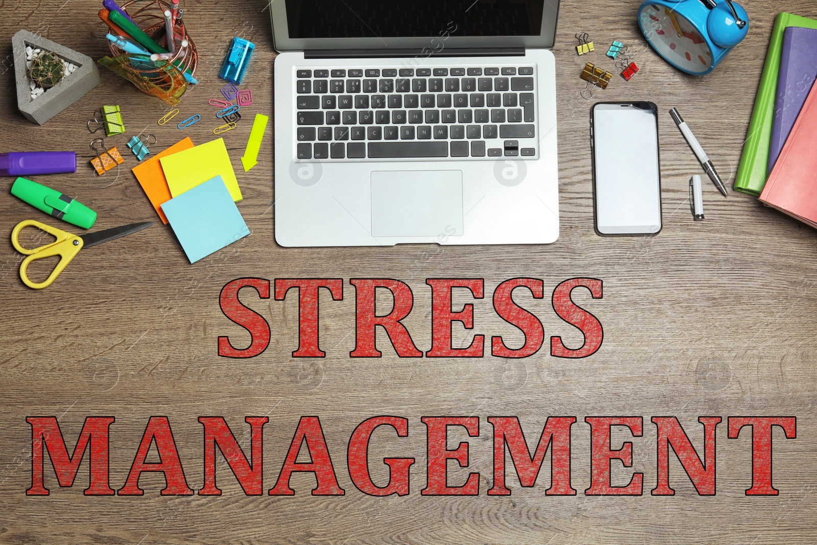 Image of Laptop, stationery and text STRESS MANAGEMENT on wooden table, flat lay