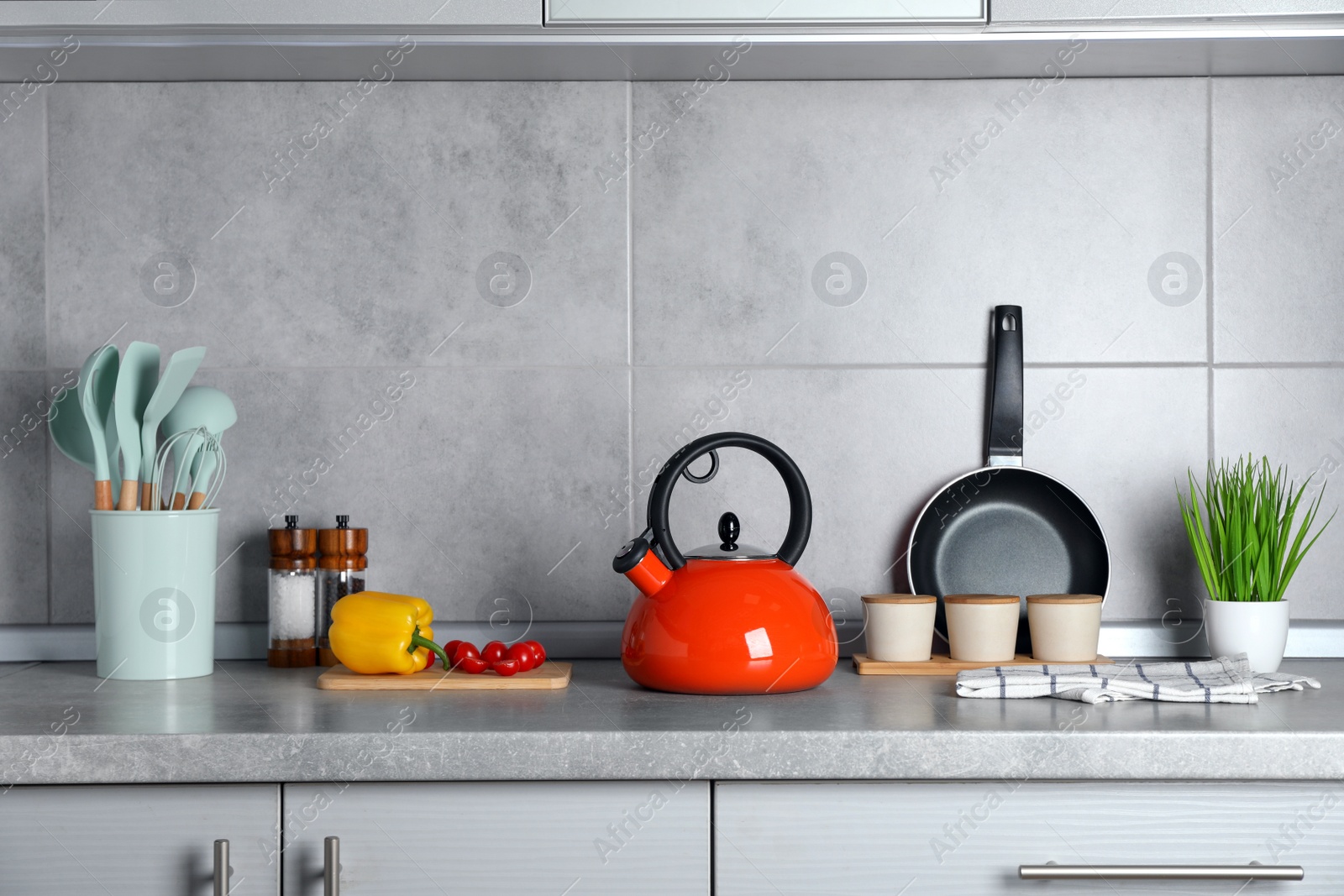 Photo of Set of different cooking utensils and products on grey countertop in kitchen