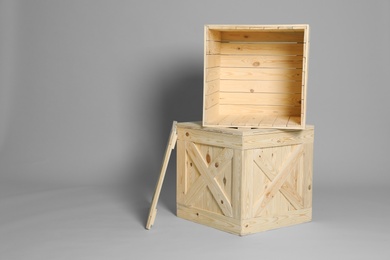 Photo of Wooden crates on grey background. Space for text