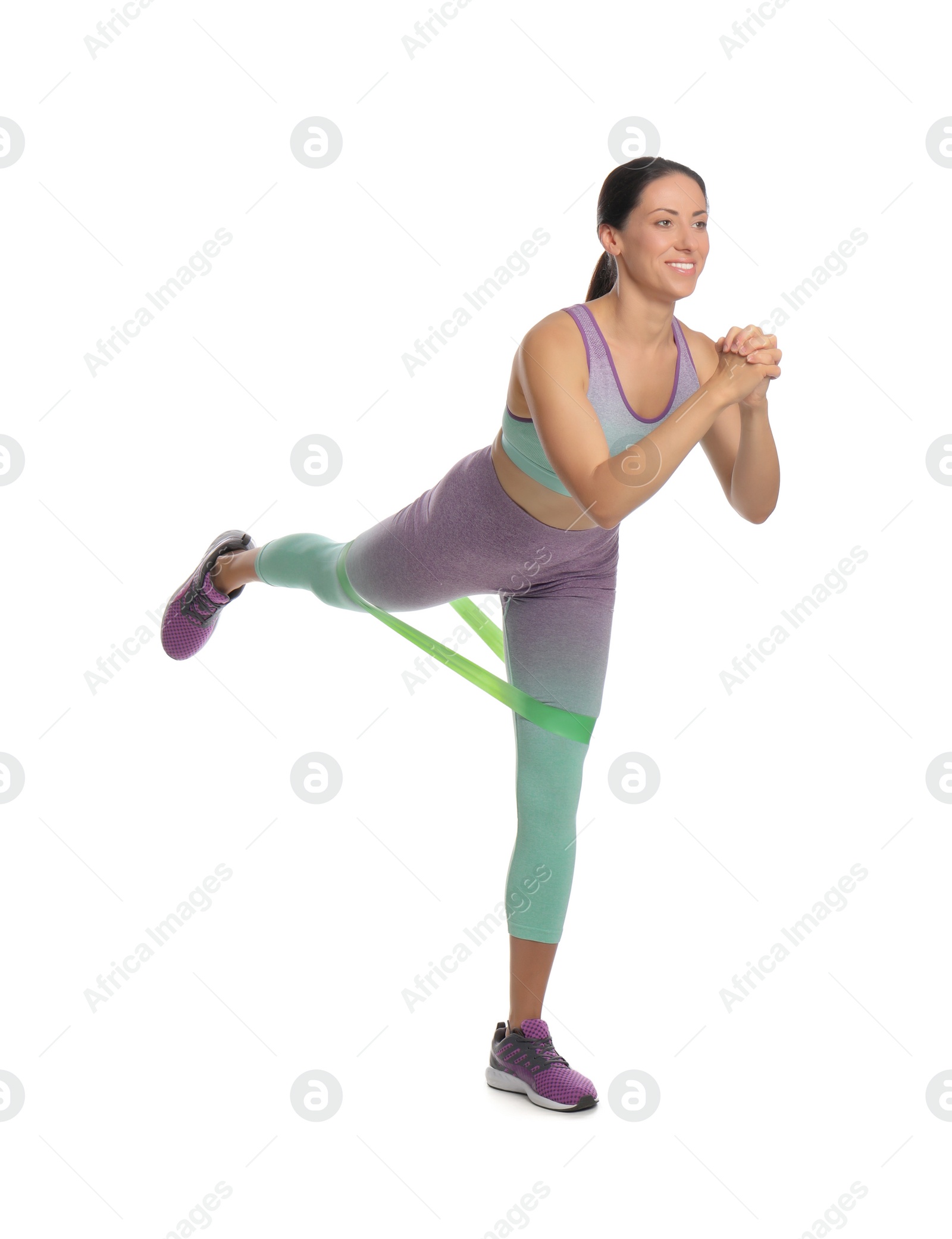 Photo of Woman doing sportive exercise with fitness elastic band on white background