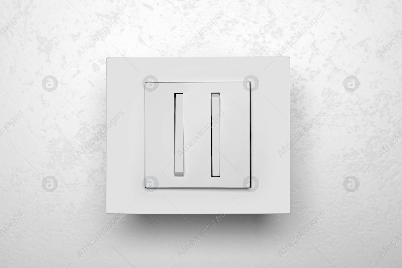 Photo of Light switch on white background, top view