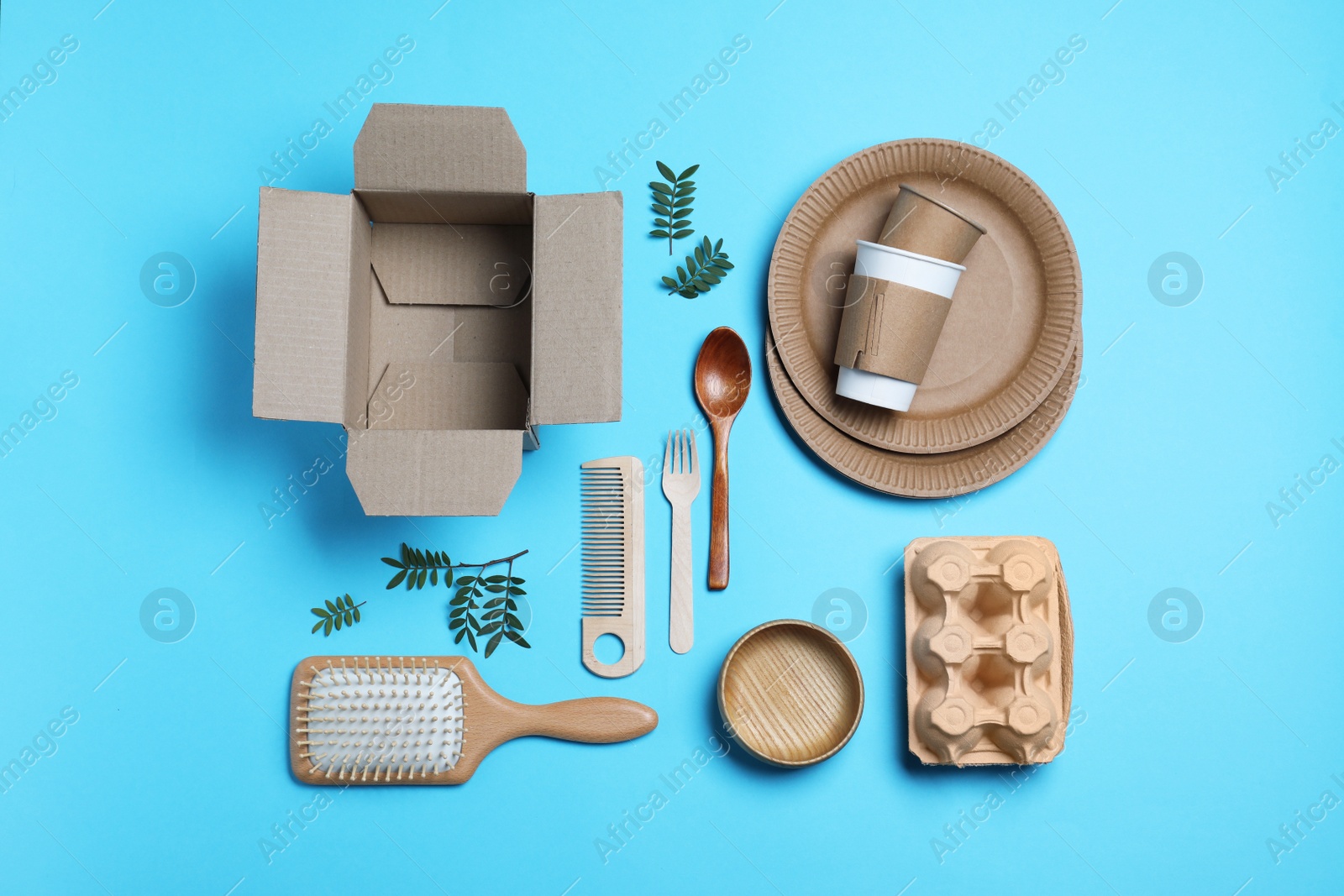 Photo of Different eco items on light blue background, flat lay. Recycling concept