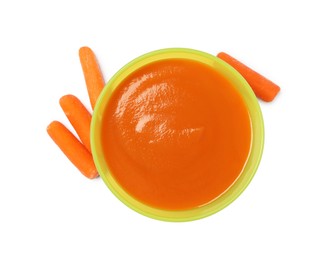 Photo of Delicious baby food in bowl and fresh carrots isolated on white, top view