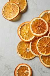 Photo of Dry orange slices on light grey table, flat lay