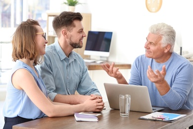 Mature manager consulting couple in office