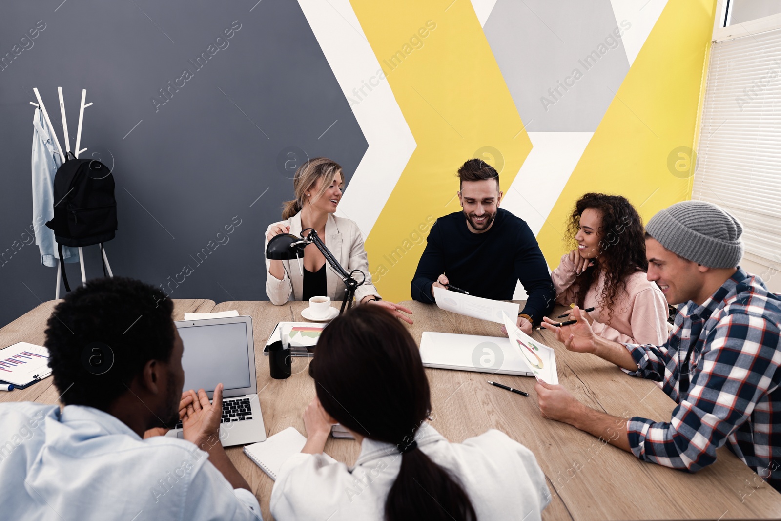 Photo of Team of employees working together in office. Startup project