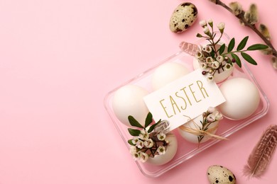 Flat lay composition with eggs, natural decor and word Easter on pink background. Space for text