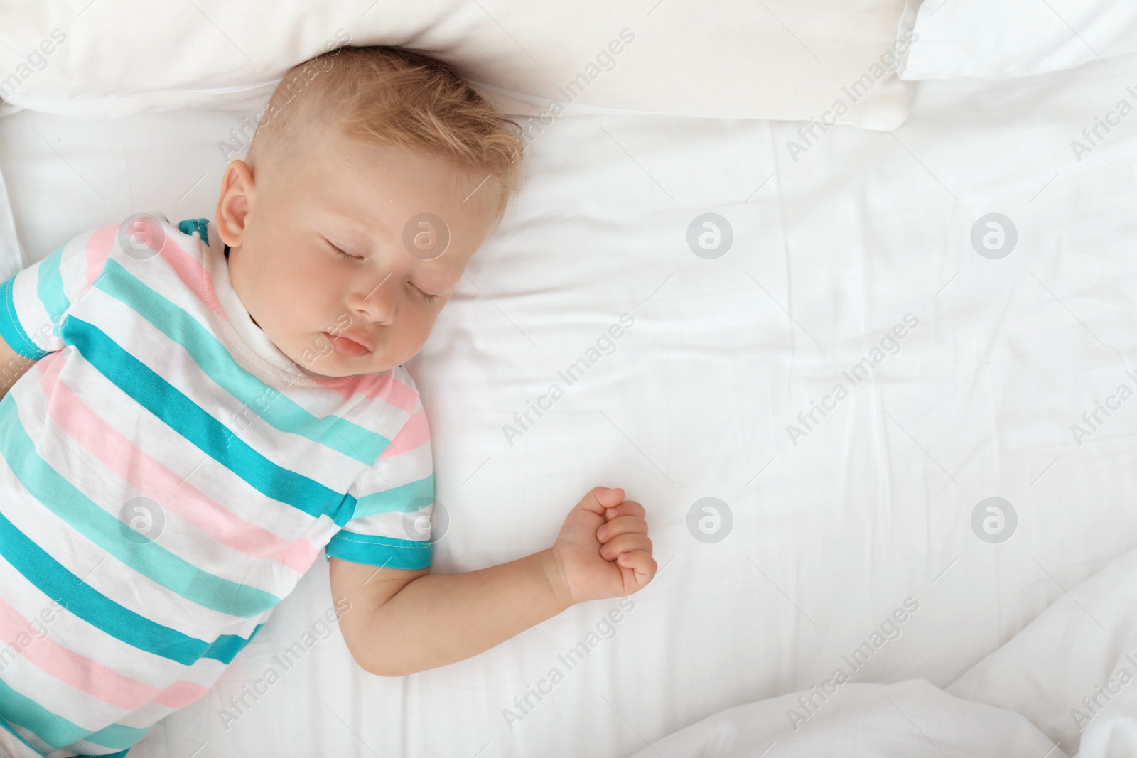 Photo of Little child sleeping on bed at home