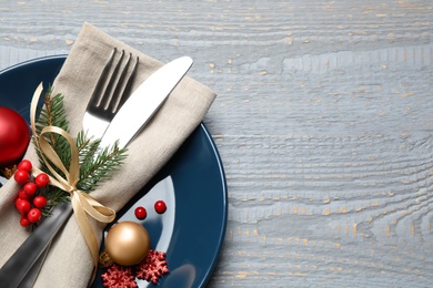 Photo of Festive table setting with beautiful dishware and Christmas decor on grey wooden background, top view. Space for text